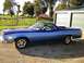1973 Ford Ranchero - This two-tone blue Ford Ranchero is parked outside a garage on a sunny day.