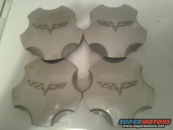 Four gray wheel center caps with Corvette flags emblem