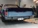 1973 Ford Ranchero - A blue Ford Ranchero with custom graphics is seen from the rear, a V8 ROX license plate.