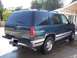 1995 Chevrolet Tahoe - Rear view of a 1995 Chevrolet Tahoe, showing its dark green paint and silver trim details.