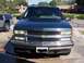 1995 Chevrolet Tahoe - 1995 Chevrolet Tahoe front view, parked outside with another truck nearby.