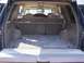 1995 Chevrolet Tahoe - View of the cargo area inside a 1995 Chevrolet Tahoe, showing the rear seats and carpeted floor.