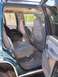 1995 Chevrolet Tahoe - The interior of a 1995 Chevrolet Tahoe shows gray cloth seats and a child safety seat installed.