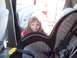 1995 Chevrolet Tahoe - A young child smiles from a car seat, viewed from the interior of the vehicle.