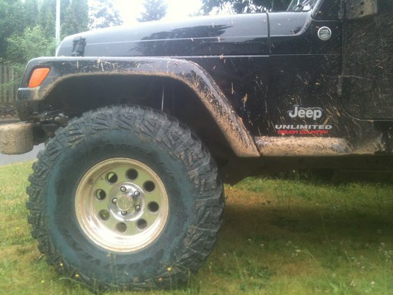 Black Jeep Wrangler Unlimited Rough Country side view with large tires