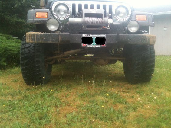 2005 Jeep Wrangler front end, dark gray, with winch, mud on bumper, and large tires