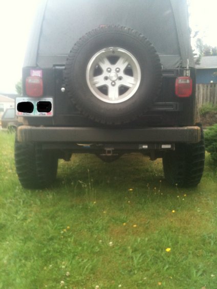 Black Jeep Wrangler rear with spare tire and trailer hitch