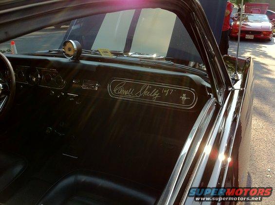 Shelby 1967 badge on car interior dashboard