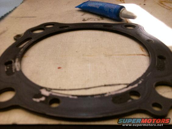 Engine gasket with sealant tube on workbench