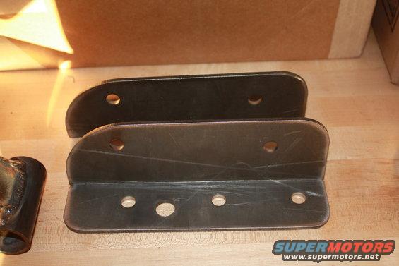 Pair of black metal brackets with multiple mounting holes