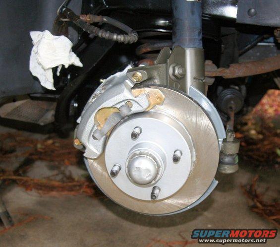Front brake assembly with silver caliper and rotor