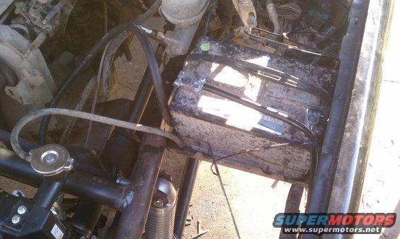 Engine bay showing battery and radiator cap