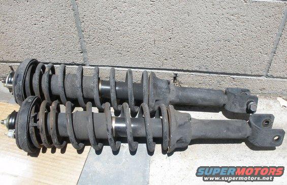 Pair of front shock absorbers with coil springs, one slightly above the other