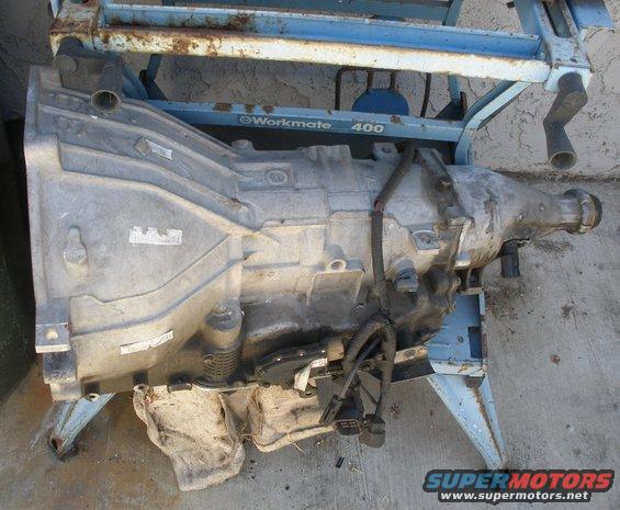 Automatic transmission on a stand. Some labels are visible on the casing