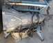 1995 Ford Thunderbird - An automatic transmission is shown mounted on a blue metal stand.