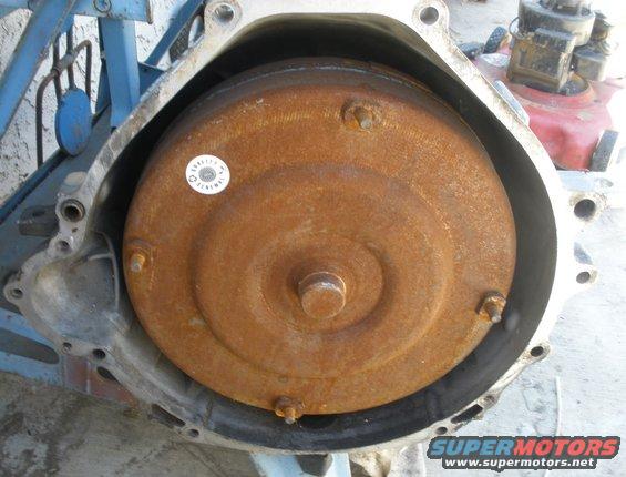 Rusty torque converter in transmission housing with a "Quality Remanufacture" sticker