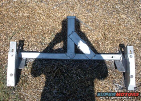 Trailer hitch receiver with square tubing and mounting brackets on ground