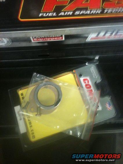 Engine gasket and ring in plastic packaging. Text on packaging includes 'COMP Cams' and 'SUPERMOTORS.net'