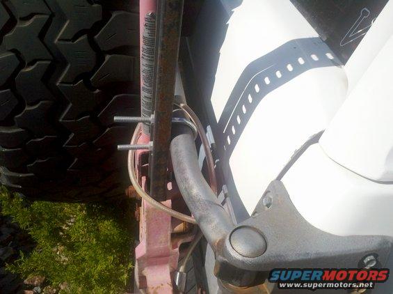Close-up of a large off-road tire and suspension components, possibly from a lifted truck or SUV