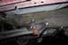 1994 Ford Bronco - Underside view of a vehicle's suspension component with a red bushing.
