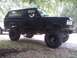 1989 Ford Bronco - Side view of a lifted black 1989 Ford Bronco with off-road tires.