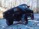 1989 Ford Bronco - This 1989 Ford Bronco is equipped with large off-road tires and is parked outdoors in a snowy environment.