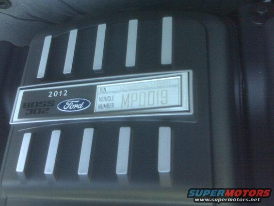 Close-up of 2012 Ford Mustang Boss 302 engine cover with VIN plate