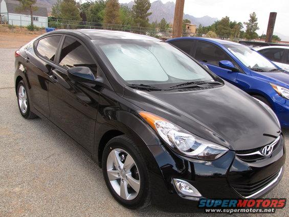 Black Hyundai Elantra parked outside with a blue car behind it