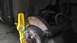 2007 Dodge Caliber - A yellow Stabila level is placed against the brake rotor and caliper assembly of a vehicle.