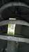 2007 Dodge Caliber - A close-up view of a car's suspension system, a yellow identification sticker with barcode and alphanumeric codes.