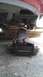 2007 Dodge Caliber - Vehicle being lifted by a jack for repairs, supported by wooden blocks.