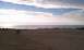 1994 Ford F-250 - Expansive sand dunes meet the ocean horizon under a partly cloudy sky.