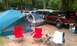 1994 Ford F-250 - A maroon SUV is parked at a campsite with tents and chairs set up.