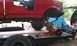 1994 Ford F-250 - Pickup truck on trailer with suspension work being done, blue tent in background.