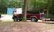 1994 Ford F-250 - A maroon Ford Expedition is parked outdoors with laundry hanging on a line behind it.
