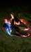 1994 Ford F-250 - A campfire burns brightly with logs and colorful flames visible in the fire pit.