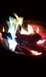 1994 Ford F-250 - Colorful flames burn in a fire pit at night, with a website logo visible.