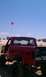 1994 Ford F-250 - A lifted red 1994 Ford F-250 with Ford decals is parked on sand dunes under a clear blue sky.