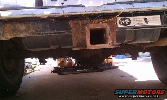 Rear trailer hitch assembly and fuel tank on a vehicle, with a 'Valley' sticker visible
