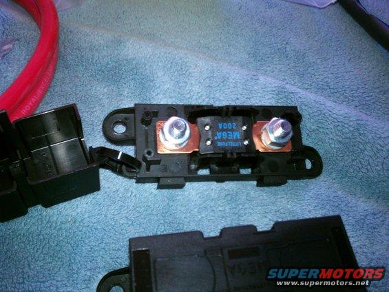 Close-up of a car's mega fuse holder with a 200A fuse and red cable