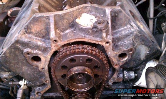 Close-up of engine timing chain and gears on a block