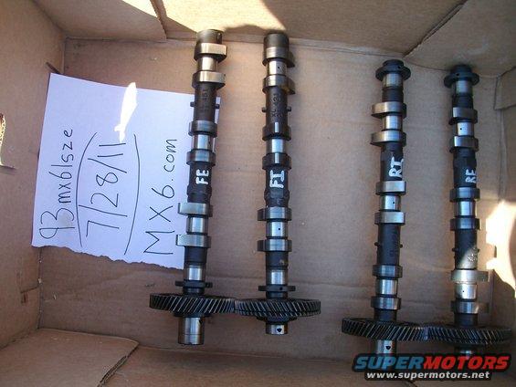 Four camshafts with gears in a cardboard box. Paper note says '93 mx6lsze 7/28/11 MX6.com'