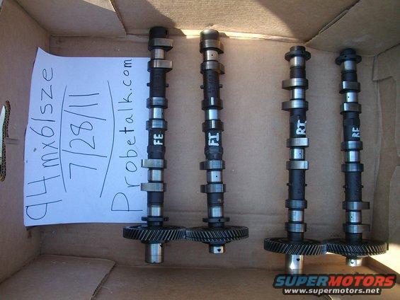 Four camshafts with gears, labeled FE, FI, RT, RE, next to a paper stating '94 mx6/size 7/28/11 probetalk.com'