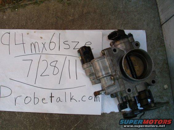 Throttle body with '94 MX6' written on paper next to it