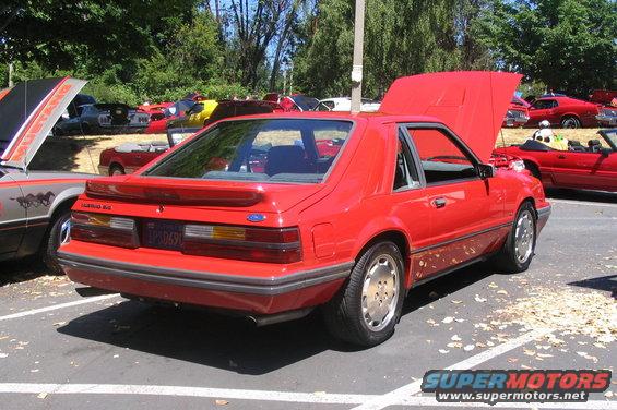 Red coupe with a spoiler and a license plate reading 'LPD 0690'