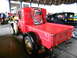 1931 Ford Model A - A red 1931 Ford Model A pickup truck is displayed indoors, a framed collage of images on its bed.