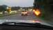 1989 Ford Bronco - A tan pickup truck with a white stripe is seen from behind on a highway as traffic passes by during dusk.