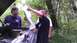 1989 Ford Bronco - Two men consult a map with the hood of a vehicle open in a wooded area.