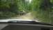 1989 Ford Bronco - A 1989 Ford Bronco navigates a challenging, rocky path through a wooded area.