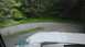 1989 Ford Bronco - Driving through a wooded area on a gravel road with a sharp curve ahead.